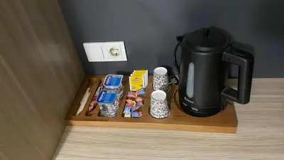 a coffee maker on a wooden tray with food and coffee at Ay suit in Esenyurt