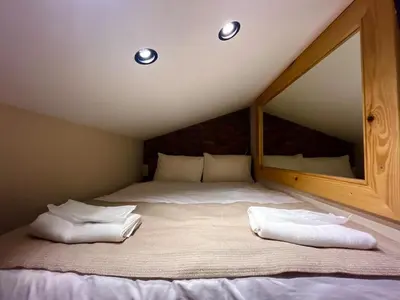 a bed with two white pillows in a attic at Wooden Villa in Istanbul