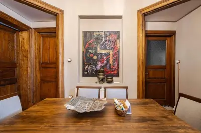 a dining room with a wooden table and a painting at Grand Historic 3BD2Bath Galata Tower Pad! #408 in Istanbul