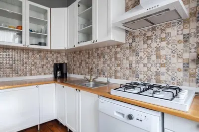 a kitchen with white cabinets and a stove top oven at Grand Historic 3BD2Bath Galata Tower Pad! #408 in Istanbul