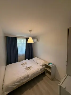 a bedroom with a bed with a lamp and a window at Şişli Suites - Room44 in Istanbul
