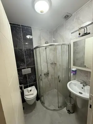a bathroom with a shower and a toilet and a sink at Şişli Suites - Room44 in Istanbul