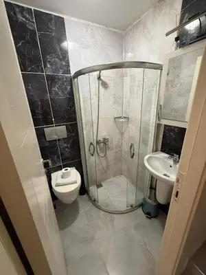 a bathroom with a shower and a toilet and a sink at Şişli Suites - Room44 in Istanbul