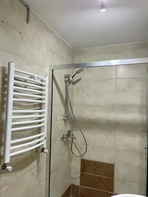 a bathroom with a shower with a glass door at Balat Homes & Apartments Nick in Istanbul