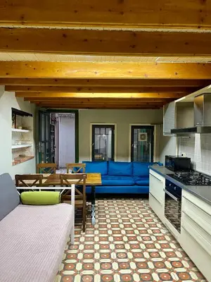 a living room with a blue couch and a table at Balat Homes & Apartments Cottage in Istanbul