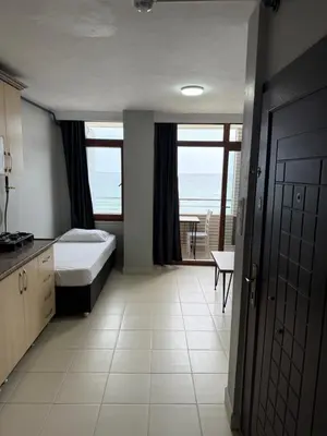 a bedroom with a bed and a view of the ocean at Rumeli Pansiyon in Kumbağ