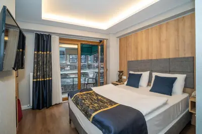 a bedroom with a large bed and a balcony at Hotel Martini in Istanbul