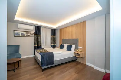 a hotel room with a bed and a chair at Hotel Martini in Istanbul
