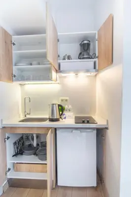 a kitchen with a sink and an open refrigerator at Firuzağa Retreat Studio in Beyoğlu in Istanbul