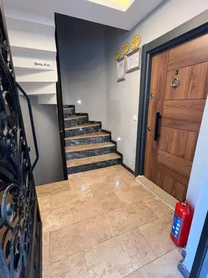 a hallway with a staircase and a wooden door at AYD Apartment Beyoğlu in Istanbul
