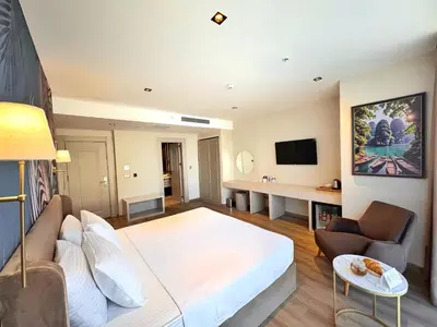 a living room with a large bed and a couch at Park Dedeman Sisli - Istanbul City Center in Istanbul