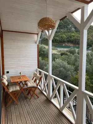 a porch with a table and chairs on a deck at Doğayla İç içe Lüks Villa in İznik