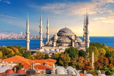 a building with two mosques with a city in the background at Sultan TG Hotel in Istanbul