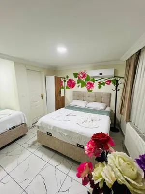 a bedroom with a bed with flowers on the wall at sefa yacht hotel in Istanbul