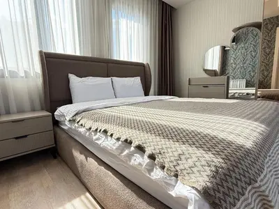 a bedroom with a large bed with a large window at 91 sqm luxury apartment with double view in Istanbul