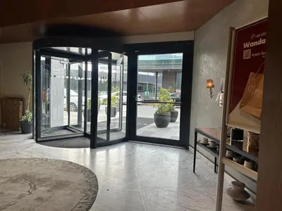 an open glass door in a store with potted plants at 91 sqm luxury apartment with double view in Istanbul