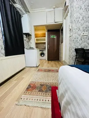 a room with a bed and a kitchen with a door at Taksim Historic House hotel in Istanbul