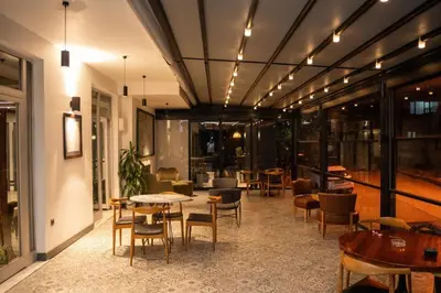 a lobby with tables and chairs in a building at Altuncu Premium Termal Hotel in Armutlu