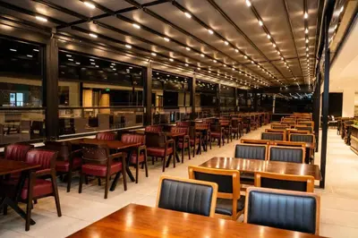 a row of tables and chairs in a restaurant at Altuncu Premium Termal Hotel in Armutlu