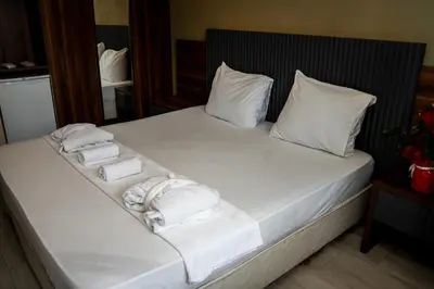 a bed with white towels and pillows on it at Altuncu Premium Termal Hotel in Armutlu