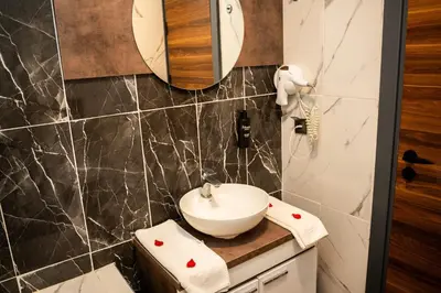 a bathroom with a sink and a mirror at Altuncu Premium Termal Hotel in Armutlu