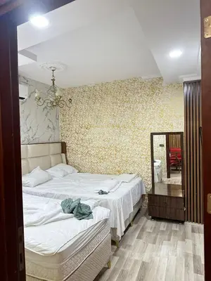 a bedroom with two beds and a mirror at Ayasofya suıtes apart otel in Istanbul
