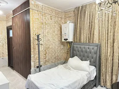 a bedroom with a bed with a cross on the wall at Ayasofya suıtes apart otel in Istanbul