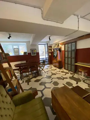 a large living room with a table and chairs at Asmaaltı GUEST HOUSE in Bursa