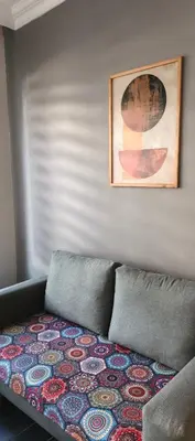 a couch sitting in a living room with a rug at Asmaaltı GUEST HOUSE in Bursa