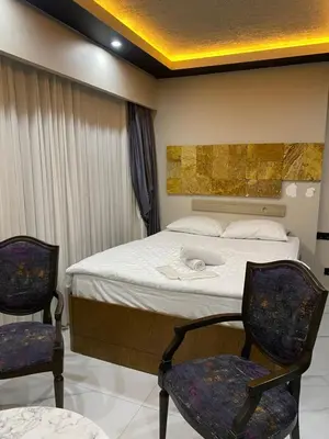 a bedroom with a bed and two chairs in it at paradise hotel in Istanbul