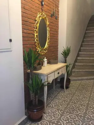 a dressing table with a mirror on a brick wall at Ozcans Pera Flats 4 in Istanbul