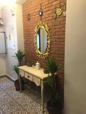 a bathroom with a mirror on a brick wall at Ozcans Pera Flats 4 in Istanbul