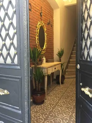 a bathroom with a sink and a mirror on a brick wall at Ozcans Pera Flats 5 in Istanbul