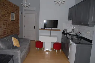 a living room with a couch and a kitchen at Ozcans Pera Flats 5 in Istanbul