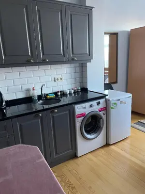 a kitchen with a washing machine and a washer at Ozcans Pera Flats 5 in Istanbul