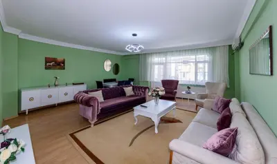 a living room with green walls and purple furniture at Şehir Manzaralı Ferah Daire in Istanbul