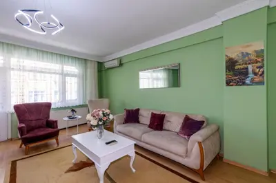 a living room with a couch and a table at Şehir Manzaralı Ferah Daire in Istanbul