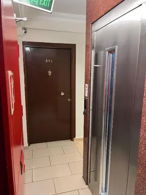 a black door in a room with a refrigerator at Adil Konak Hotel in Istanbul