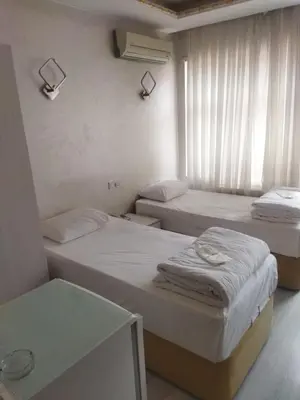 a room with two beds and a window at Adil Konak Hotel in Istanbul