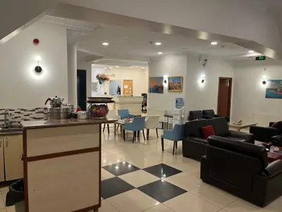 a kitchen and living room with couches and a table at Adil Konak Hotel in Istanbul