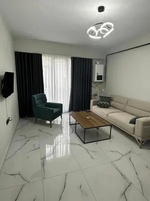 a living room with a couch and a table at Royal Suit in Bandırma