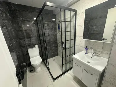 a bathroom with a shower and a toilet and a sink at Royal Suit in Bandırma