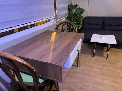a table and chairs in a room with a couch at Konakkoy 1 in Istanbul