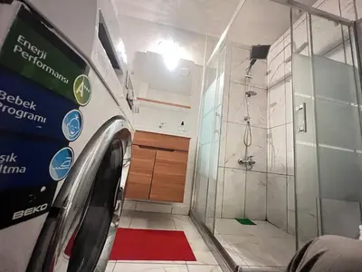 a bathroom with a shower and a washing machine at Konakkoy 1 in Istanbul