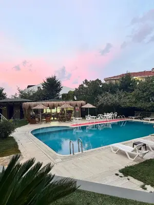 a large swimming pool with chairs and umbrellas at Treekos Boutique Hotel Istanbul Airport in Karaburun