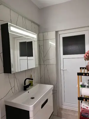 a bathroom with a white sink and a mirror at Quiet House in İznik