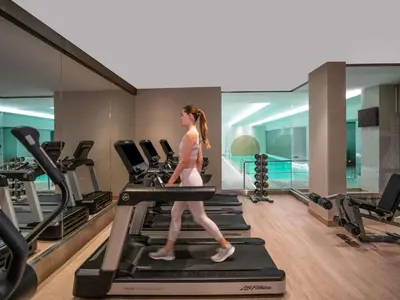 a woman walking on a treadmill in a gym at Novotel Istanbul Bosphorus Hotel in Istanbul