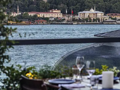 a view of a body of water with tables and wine glasses at Novotel Istanbul Bosphorus Hotel in Istanbul