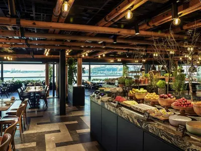 a buffet line with fruits and vegetables on display in a restaurant at Novotel Istanbul Bosphorus Hotel in Istanbul