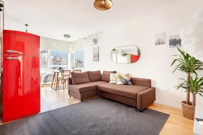 a living room with a couch and a red refrigerator at Magnificent View Great Location in Istanbul